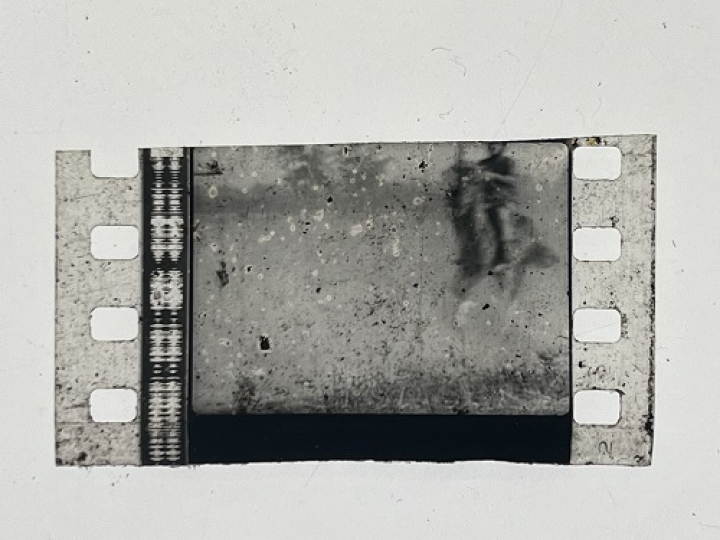35mm film fragment depicting a man on a horse.