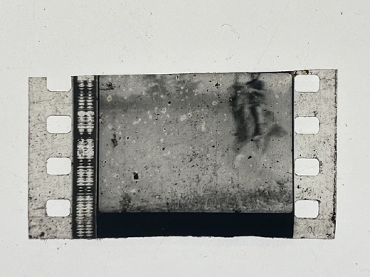 35mm film fragment depicting a man on a horse.