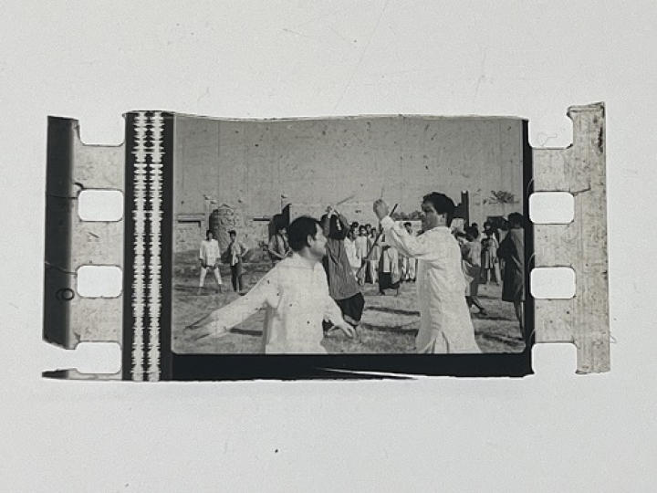 35mm film frames depicting men in white fighting.
