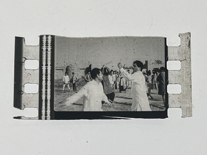35mm film frames depicting men in white fighting.