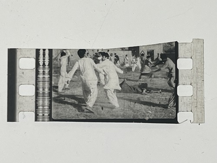 35mm film frames depicting men in white fighting.