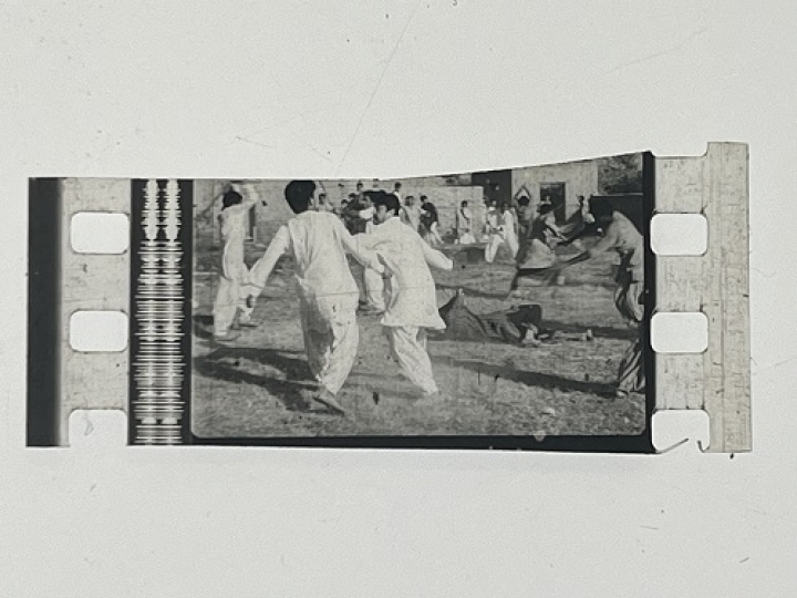 35mm film frames depicting men in white fighting.