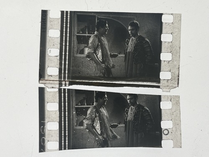 35mm film fragment depicting Sultan Rahi with a man.