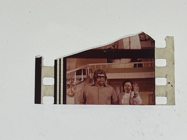 35mm film fragment depicting man and woman.