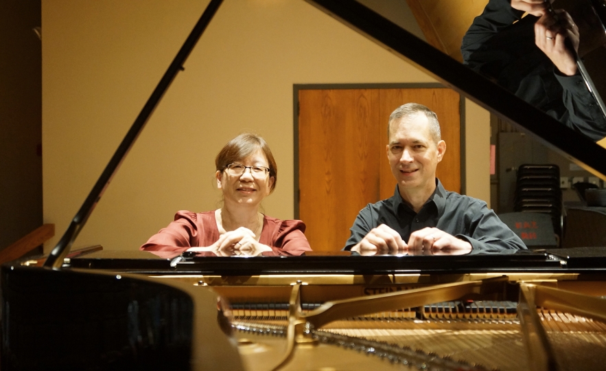 Bonnie Choi and Kevin Nitsch seated at a grand piano