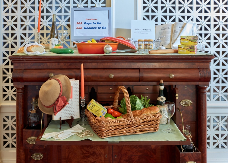 Display of cooking props and artificial food on a butler's desk