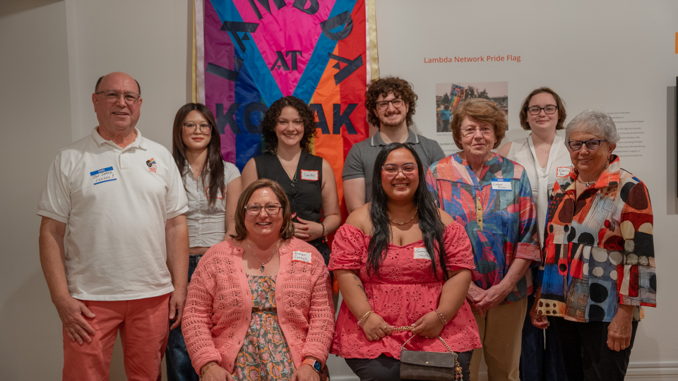 "Lambda leaders Dan Sapper, Kathryn Rivers, and Emily Jones with RIT student researchers and project lead Dr. Tamar Carroll at the Picturing Equality opening reception.  Left to right, standing in back: Dan Sapper, Melissa Xie, Cassidy Wall, Kyle Messerle, Kathryn Rivers, Noelle Marino, Emily Jones. Seated in front: Tamar Carroll and Emmarose Tabin."