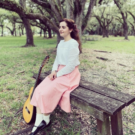 Portrait of Rachel Ginebra with guitar