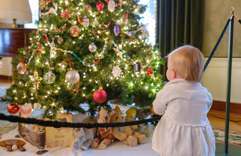 Girl in front of holiday decorations