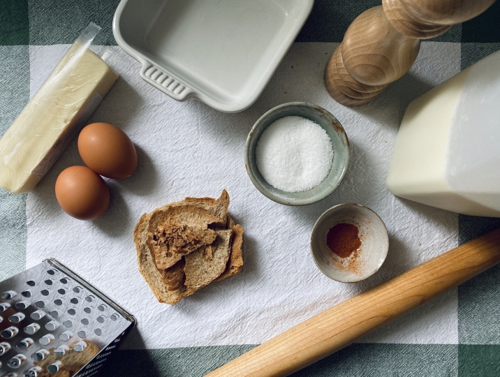 Ingredients for a recipe, including eggs, butter, salt, and some utensils