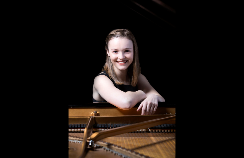 Woman in front of piano