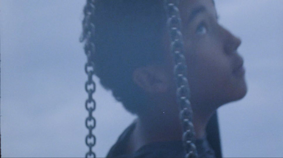 Close-up of a person on a chain swing 