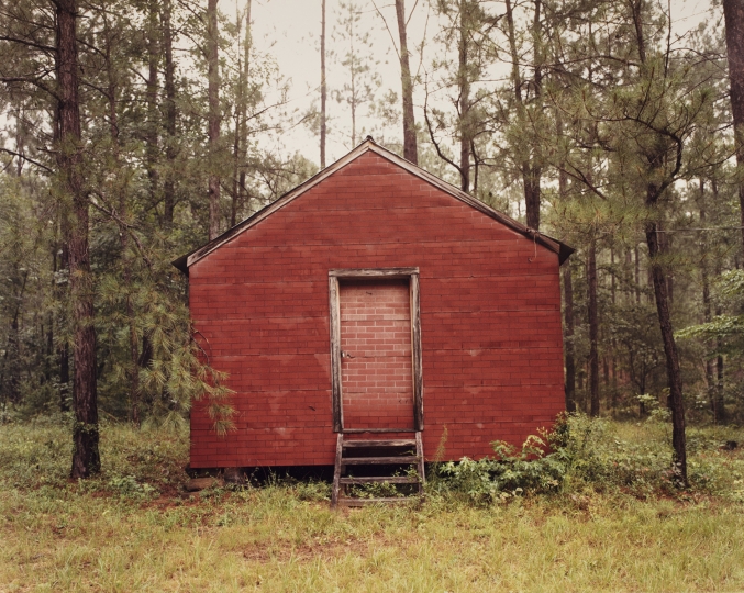 William Christenberry (American, 1936–2016), <em>Red Building in Forest, Hale County, Alabama</em>, 1983. Chromogenic development print, printed 1985. George Eastman Museum, purchase with funds from the Lila Acheson Wallace Foundation, 1985. 