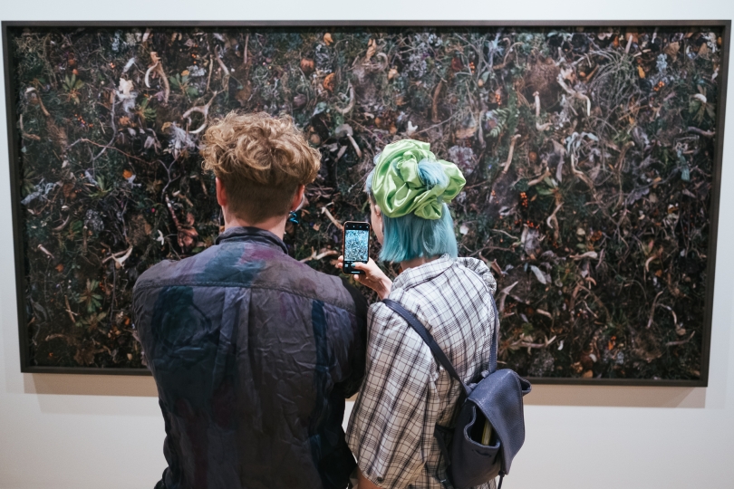 Two people standing in front of work by Tanya Marcuse