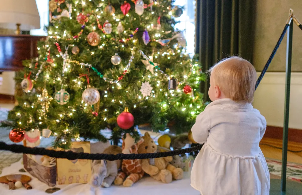 Girl in front of holiday decorations
