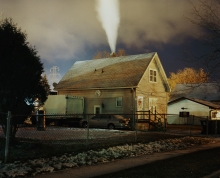 A house with steam coming out of the chimney 
