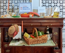 Display of cooking props and artificial food on a butler's desk