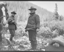 George Eastman and another man dressed in warm clothes outside in Alaska, George Eastman is leading a horse