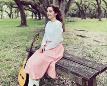 Portrait of Rachel Ginebra with guitar