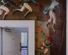 Photograph by Andrew Moore depicting a doorway surrounded by a painted mural of soldiers