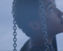 Close-up of a person on a chain swing 
