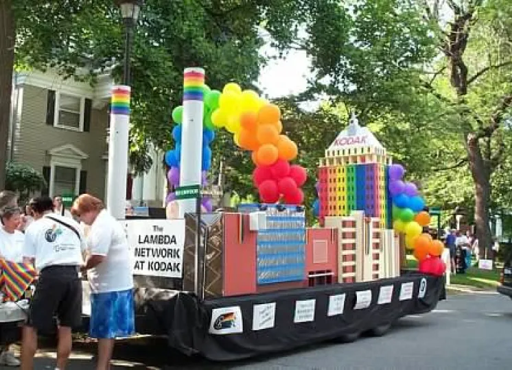 Lambda Network members, including Emily Jones on left and Pam Barres on rights, prepare to march in the 2002 Pride Parade in Rochester. The buildings on the float represent major Kodak facilities including the smokestacks of Kodak Park, Building 23, Building 28 (now Theater on the Ridge) and Kodak Tower, the widows of which were made from pieces of film. Lambda won the Stonewall Award from the Gay Alliance of the Genessee Valley for the not-for-profit group that most imaginatively depicts the year's parade 