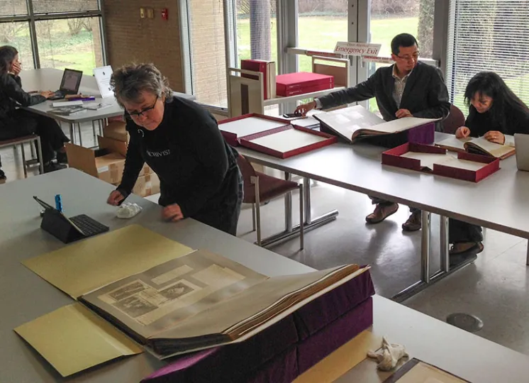 Researchers in the library looking at historic books