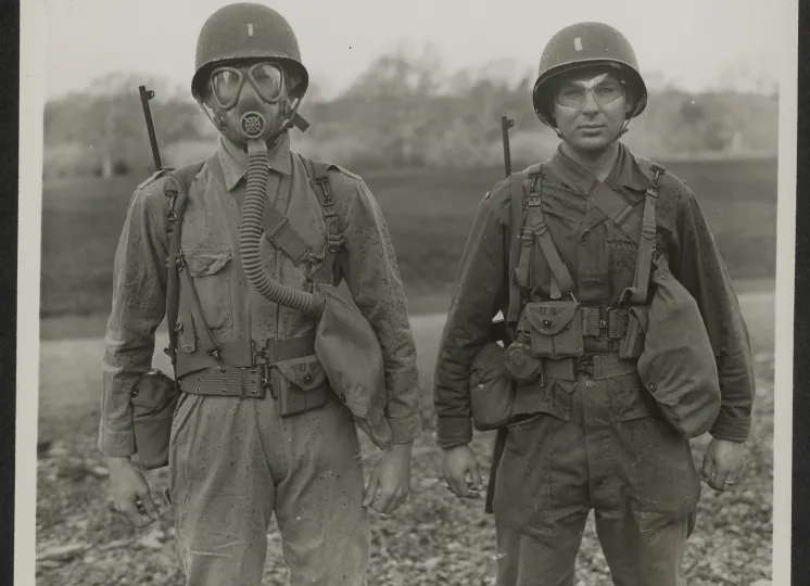 Two Students Demonstrate the Importance of Eye Shields and Gas Masks at a Gas School in Northern Ireland, January 14, 1944.