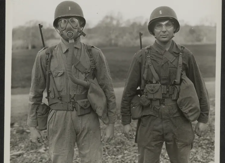 Two Students Demonstrate the Importance of Eye Shields and Gas Masks at a Gas School in Northern Ireland, January 14, 1944.