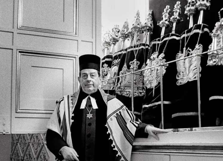 Rabbi standing against a counter 