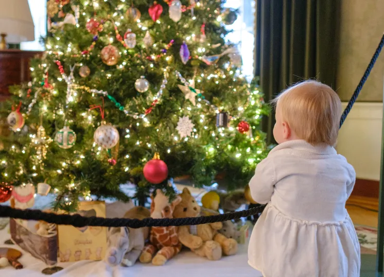 Girl in front of holiday decorations