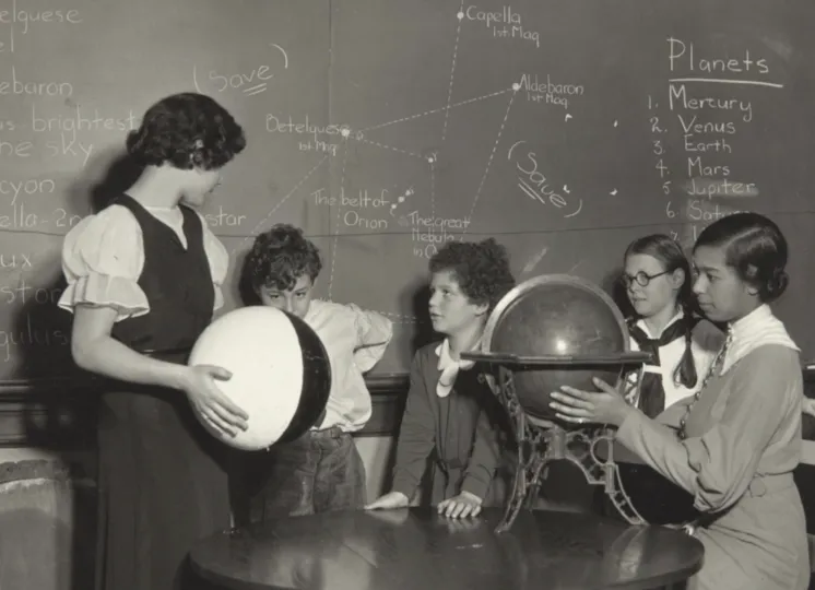 Photograph of four students and a teacher