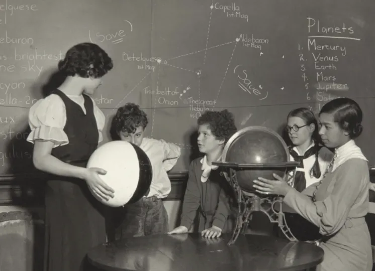Photograph of four students and a teacher
