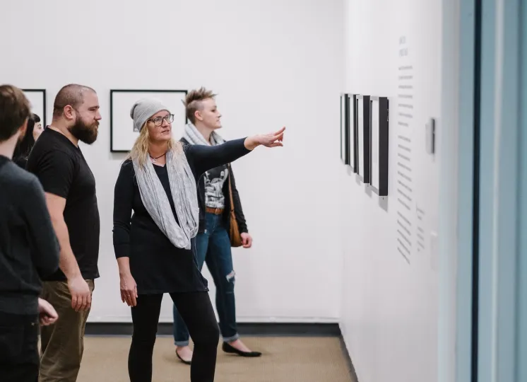 Guests in gallery looking at photographs