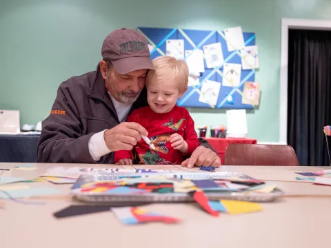 Family making gingerbread craft 