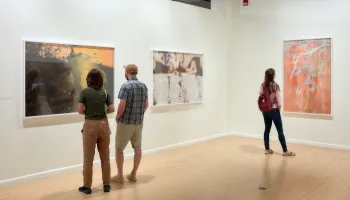 Guests in gallery looking at photographs