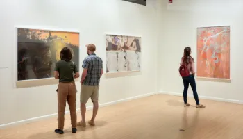 Guests in gallery looking at photographs