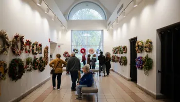 individuals in a hallway looking at a wreath display,undefined