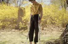 Portrait of a young person missing a shoe and is on crutches