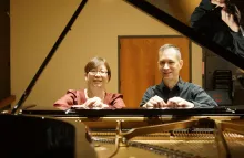 Bonnie Choi and Kevin Nitsch seated at a grand piano
