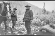 George Eastman and another man dressed in warm clothes outside in Alaska, George Eastman is leading a horse