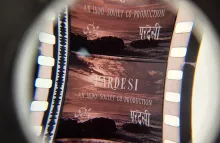 Magnified motion picture film strip depicting an ocean scene overlaid with the words Pardesi, An Indo-Soviet Production
