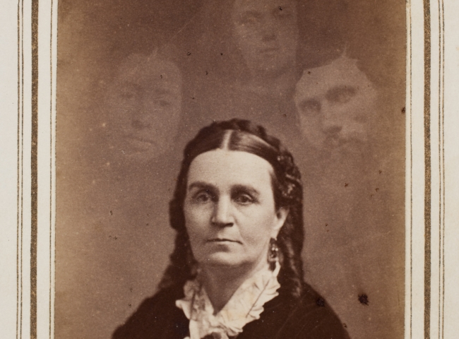 Woman with three ghostly heads surrounding her
