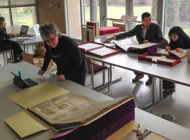 Researchers in the library looking at historic books