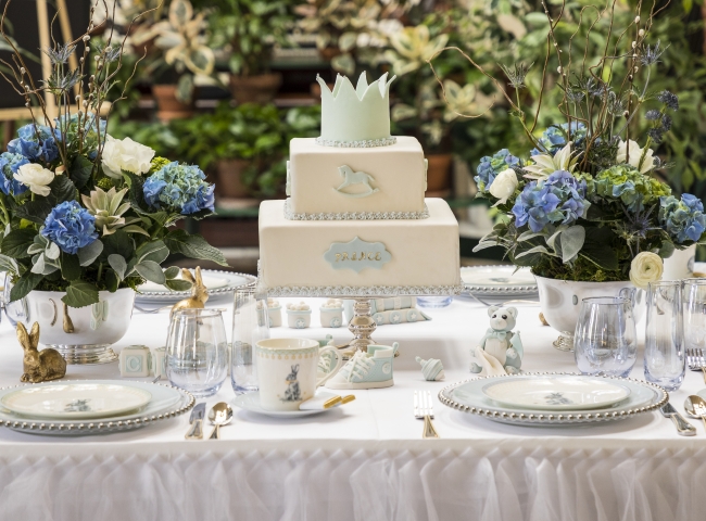 table set with place settings and a tiered cake