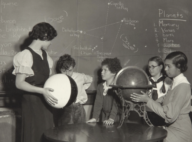 Photograph of four students and a teacher