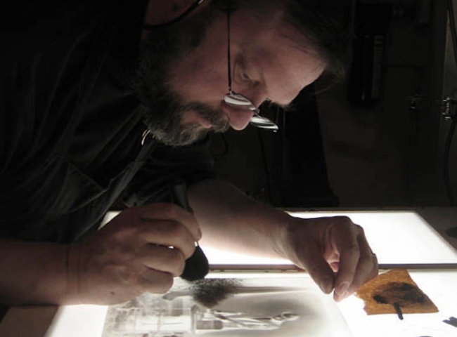 Mark retouching a glass plate photograph