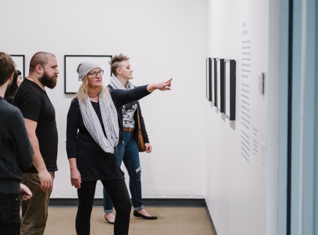 Guests in gallery looking at photographs