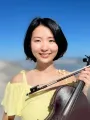 Headshot of Cindy Shang, facing camera and smiling and holding a violin
