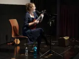 Maggie Paxson singing and playing ukulele in a performance at the George Eastman Museum